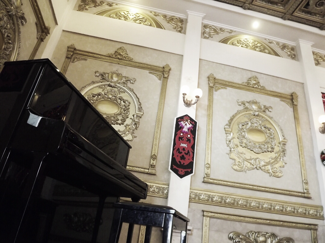 Wall ornaments and a stand piano